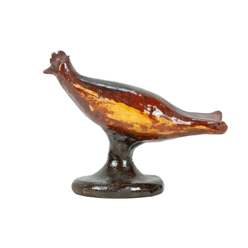 626 - A primitive slipware pottery bird whistle. Early-mid 19th century, on a waisted circular base, heigh... 
