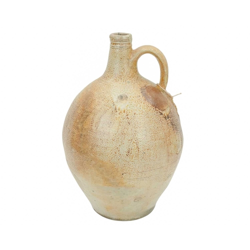 628 - A large English salt glazed wine jug or flagon. Circa 1630, with a typical mottled glaze and narrow ... 