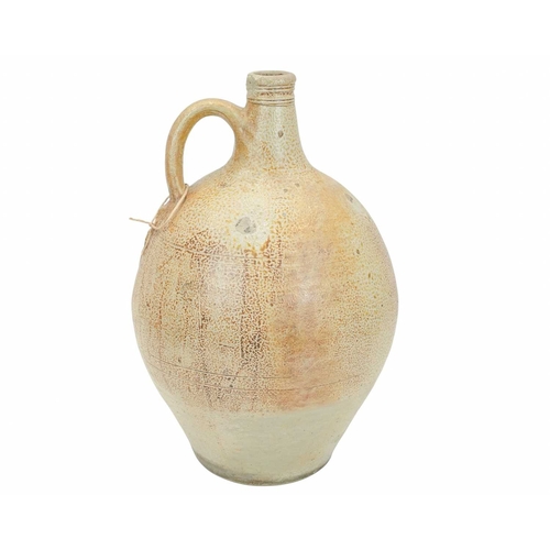 628 - A large English salt glazed wine jug or flagon. Circa 1630, with a typical mottled glaze and narrow ... 