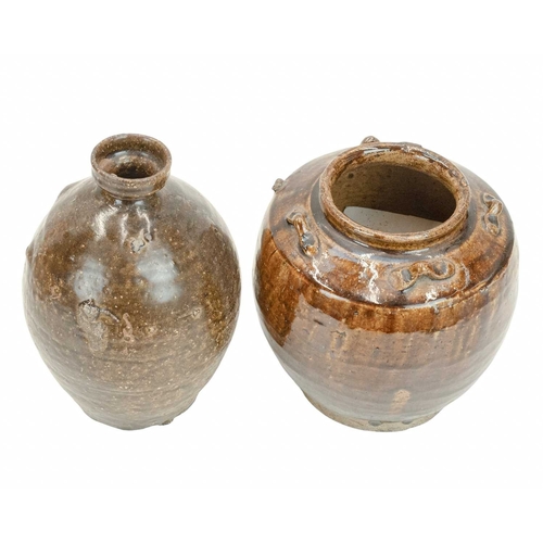 632 - Two Korean pots. 18th century or earlier, each with a deep brown glaze, the first with an ovoid body... 