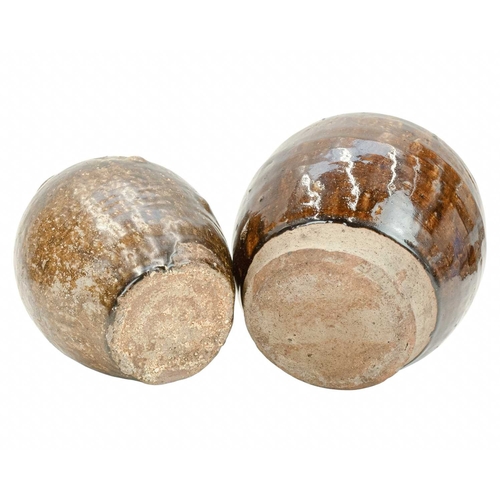 632 - Two Korean pots. 18th century or earlier, each with a deep brown glaze, the first with an ovoid body... 