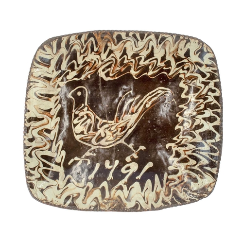 633 - An English slipware pottery dish, dated 1791. Painted in a cream and brown slip with a stylized phea... 