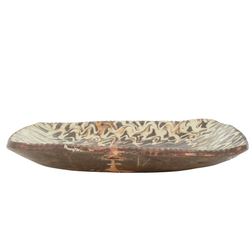 633 - An English slipware pottery dish, dated 1791. Painted in a cream and brown slip with a stylized phea... 