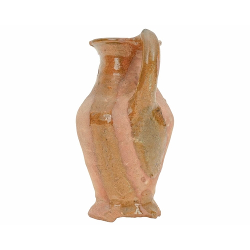 640 - An English post-medieval redware earthenware jug. The clear glazed interior extends to the handle an... 