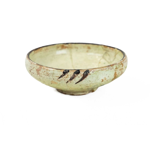 644 - A Persian Kashan pottery small bowl. 12th/13th century, the ivory ground slip decorated with simple ... 