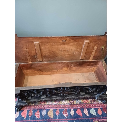 651 - An Italian walnut cassone. 18th century, the hinged lid with a gadrooned edge, the well carved front... 