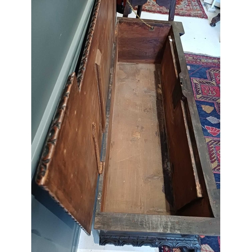 651 - An Italian walnut cassone. 18th century, the hinged lid with a gadrooned edge, the well carved front... 