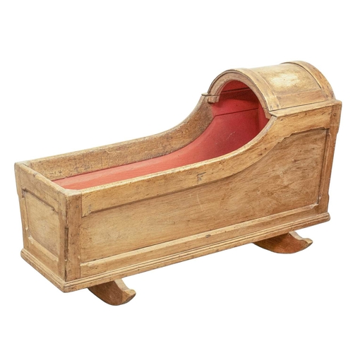 652 - A pine rocking baby crib. 19th century, panelled with a domed hood and painted interior, height 60cm... 
