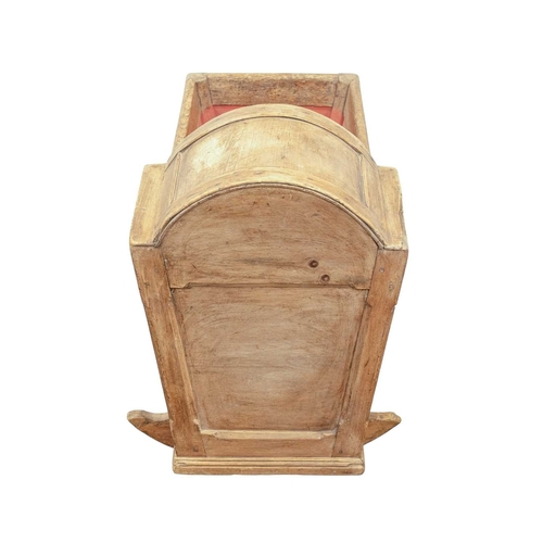 652 - A pine rocking baby crib. 19th century, panelled with a domed hood and painted interior, height 60cm... 