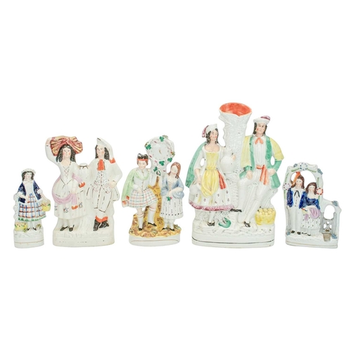 653 - Seven Victorian Staffordshire figures and groups. Including a porcelanous group of lovers under an a... 