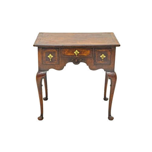 654 - A George II style walnut lowboy. The herringbone banded top with re-entrant corners above a small ce... 