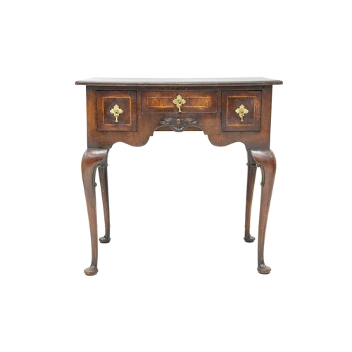 654 - A George II style walnut lowboy. The herringbone banded top with re-entrant corners above a small ce... 
