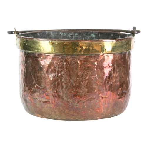 655 - A large copper cauldron or log bin, 19th century. With brass band to rim, and cast iron swing handle... 