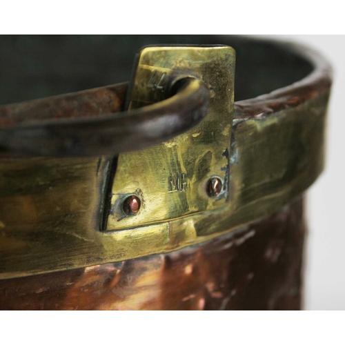 655 - A large copper cauldron or log bin, 19th century. With brass band to rim, and cast iron swing handle... 