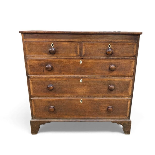 657 - A 19th century oak and crossbanded chest. Fitted two short and three long drawers with turned wooden... 