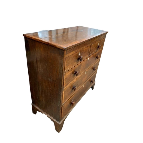 657 - A 19th century oak and crossbanded chest. Fitted two short and three long drawers with turned wooden... 