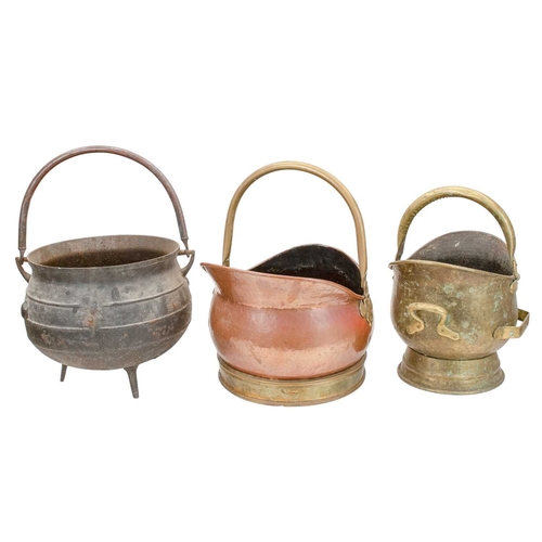 662 - A cast iron cauldron. Of bulbous form, on three feet with angular lugs and a copper handle, the band... 
