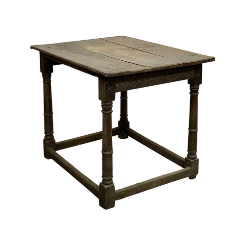 686 - A 17th century oak side table. With a three plank top and raised on gunbarrel turned legs with stret... 