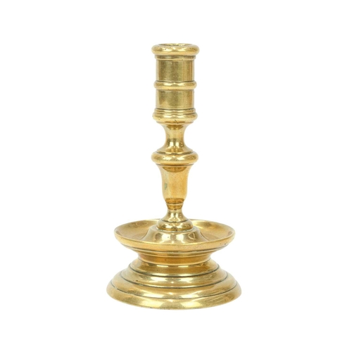 688 - A 17th century style Dutch brass taper stick. With a baluster stem, lower drip pan and bell shape ba... 