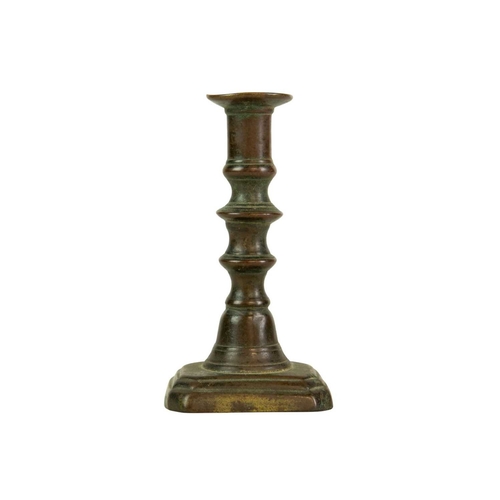 688 - A 17th century style Dutch brass taper stick. With a baluster stem, lower drip pan and bell shape ba... 