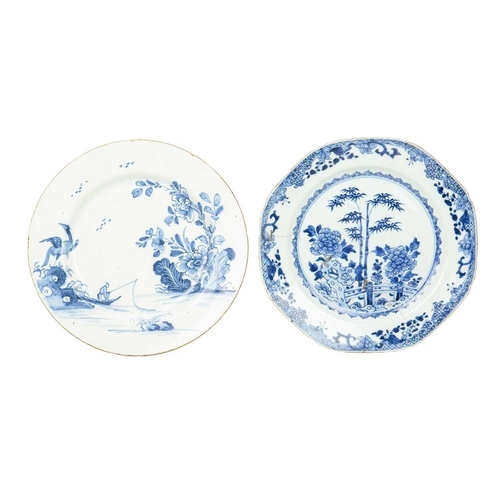 696 - An English Delft plate, circa 1780. Painted in blue with an oriental pheasant, a fisherman, and flow... 