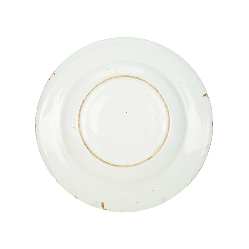 696 - An English Delft plate, circa 1780. Painted in blue with an oriental pheasant, a fisherman, and flow... 