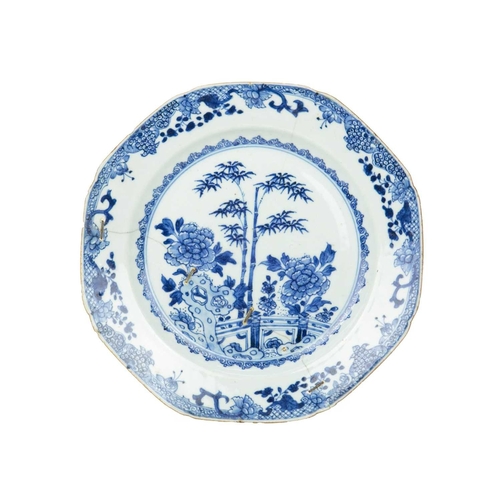 696 - An English Delft plate, circa 1780. Painted in blue with an oriental pheasant, a fisherman, and flow... 