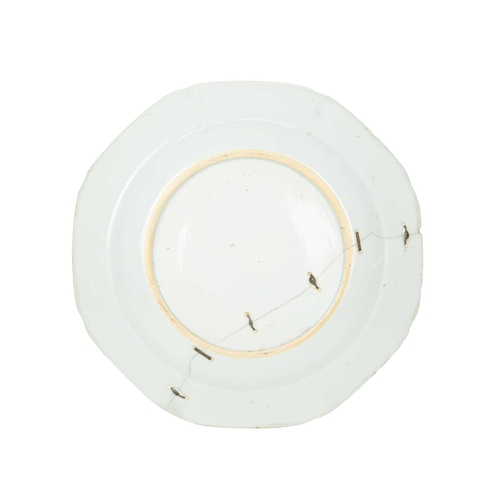 696 - An English Delft plate, circa 1780. Painted in blue with an oriental pheasant, a fisherman, and flow... 