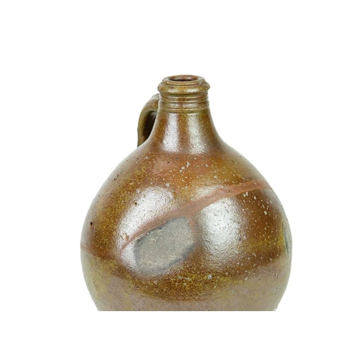 712 - A 17th century German salt-glazed stoneware jug. With a simple loop handle, height 30cm.