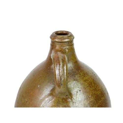 712 - A 17th century German salt-glazed stoneware jug. With a simple loop handle, height 30cm.