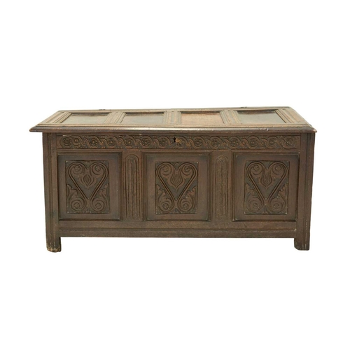 713 - An oak panel coffer. West Country, probably Somerset, 17th century, with a four panel lid above a gu... 