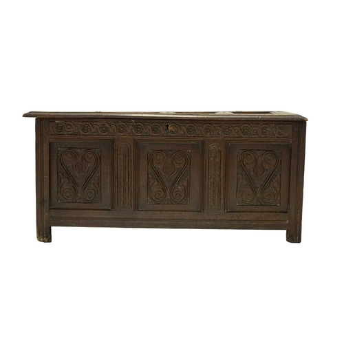 713 - An oak panel coffer. West Country, probably Somerset, 17th century, with a four panel lid above a gu... 
