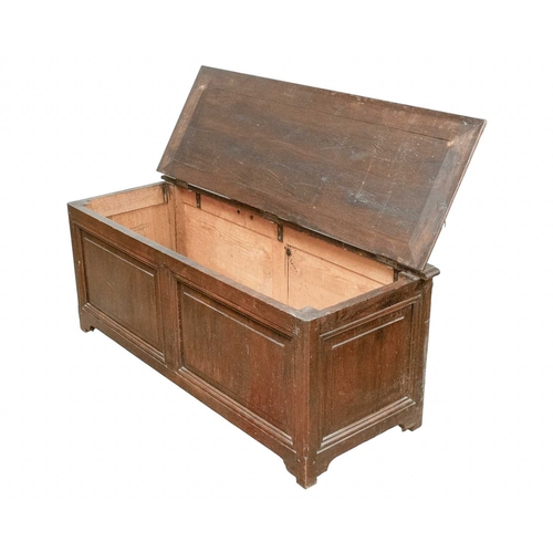 716 - An oak panel coffer. 19th century, with a hinged lid and fielded panel front, height 55cm, width 139... 
