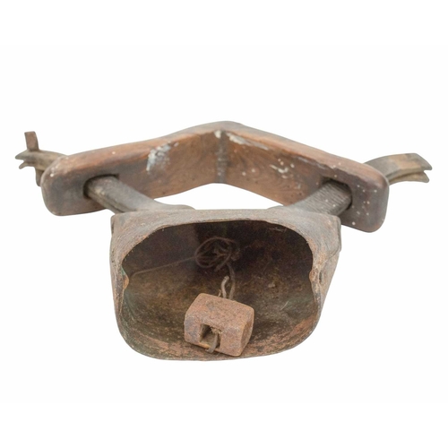 722 - A 19th century 'clucket' type sheep bell. The iron bell attached to a wooden yoke neck-piece with le... 
