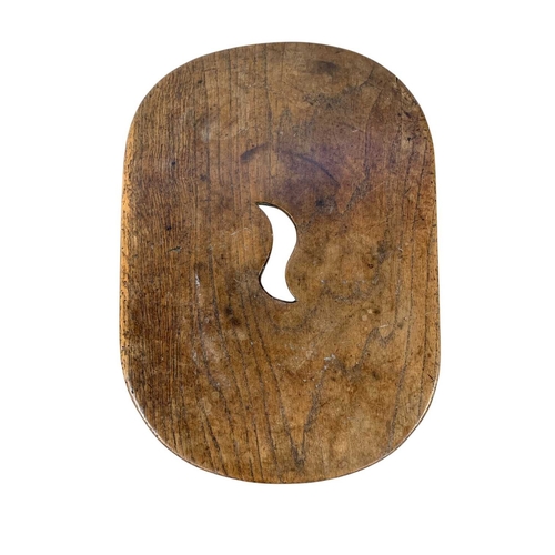 723 - A George III elm and oak stool. The top pierced with a central aperture, raised on square moulded le... 