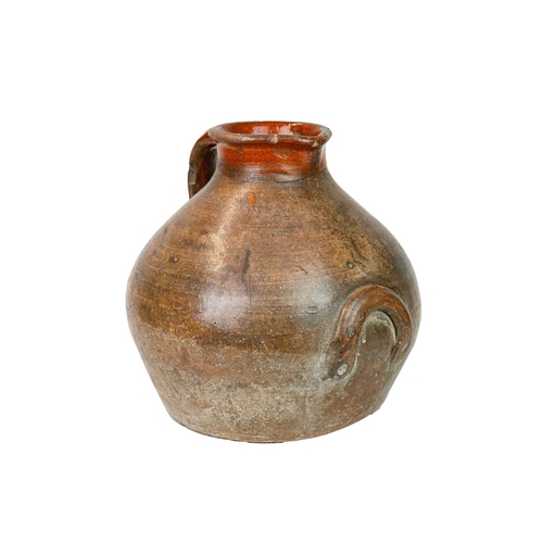 725 - A large pottery storage jug. 18th century, with a broad, rounded body and unglazed exterior, with a ... 