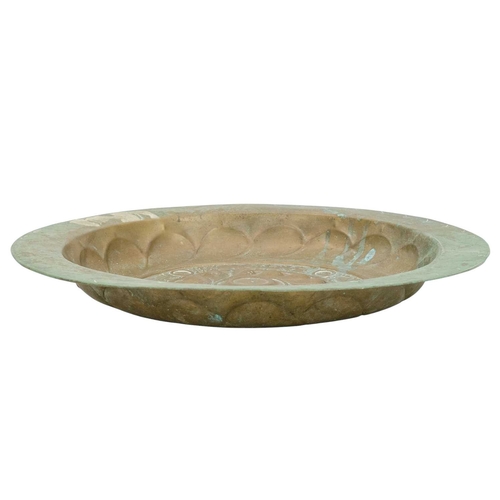 727 - A 17th century Nuremberg brass alms dish. With a central rosette within a Gothic inscription interse... 