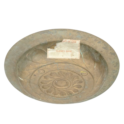 727 - A 17th century Nuremberg brass alms dish. With a central rosette within a Gothic inscription interse... 