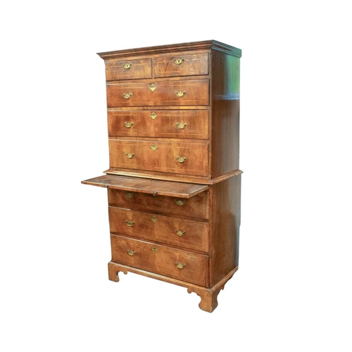 730 - An 18th century walnut chest on chest. The upper part with a moulded cornice above two short and thr... 