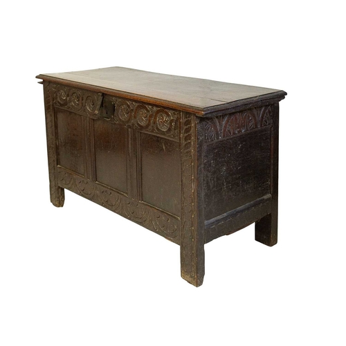 741 - An 18th century oak panel coffer. The triple panel front with a guilloche carved frieze and reverse ... 