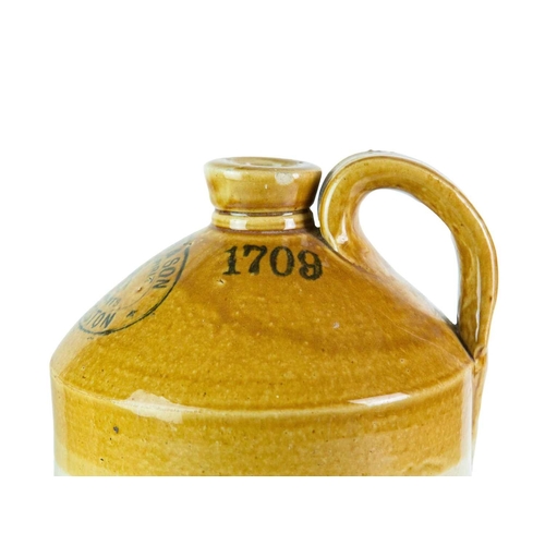 748 - Local interest. Three Launceston stoneware flagons. A 'Francis & Son Wine & Spirit Merchants' flagon... 