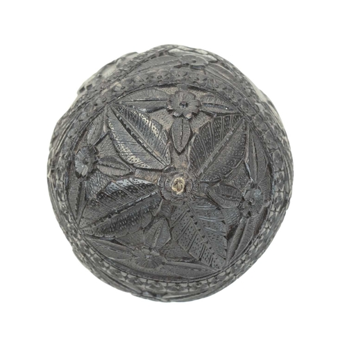 750 - A carved coconut bugbear money box. 19th century, with four carved panels of figures, male and femal... 