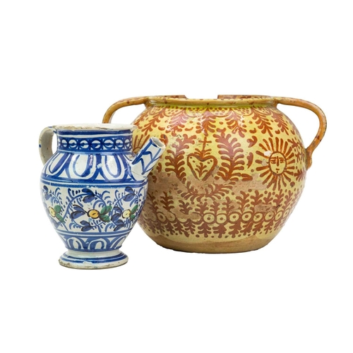 751 - A Continental faience twin handled jar. Possible French or Spanish, 18th/19th century, the ochre gro... 