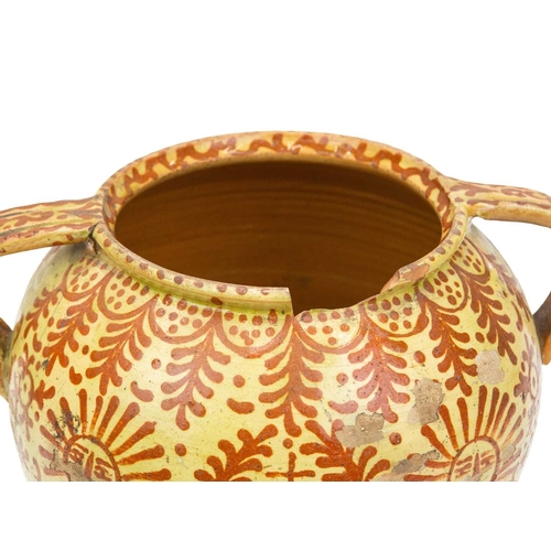 751 - A Continental faience twin handled jar. Possible French or Spanish, 18th/19th century, the ochre gro... 