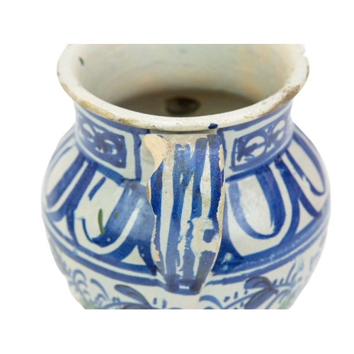 751 - A Continental faience twin handled jar. Possible French or Spanish, 18th/19th century, the ochre gro... 