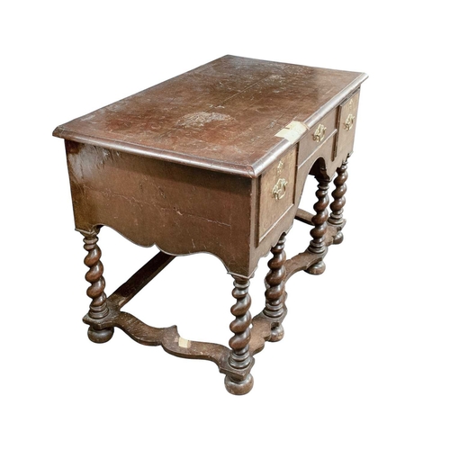 752 - A William and Mary style walnut side table. 18th/19th century, with a quarter veneered top above thr... 