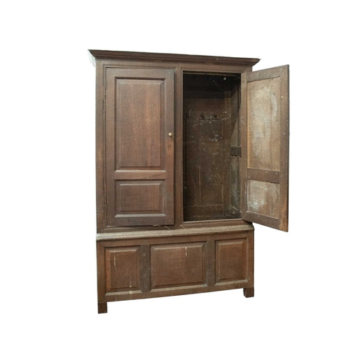 757 - An early George III oak press cupboard. With panelled doors, base and sides, fitted with a hanging r... 