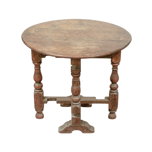 765 - A circular joined oak drop top occasional table. Circa 1900, in the 17th century style, with a twist... 