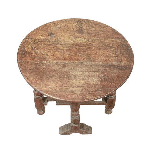 765 - A circular joined oak drop top occasional table. Circa 1900, in the 17th century style, with a twist... 
