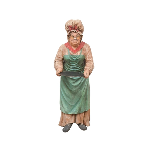 77 - A novelty dumbwaiter. Modelled as an elderly lady wearing a mob cap, glasses, and a green apron over... 